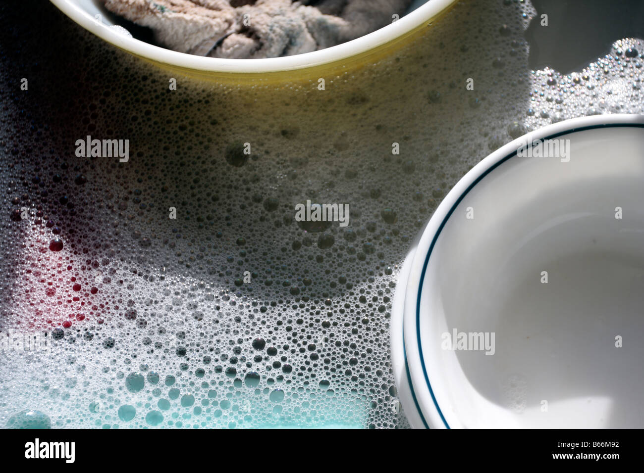 Glass dishes in soapy dish water Stock Photo Alamy