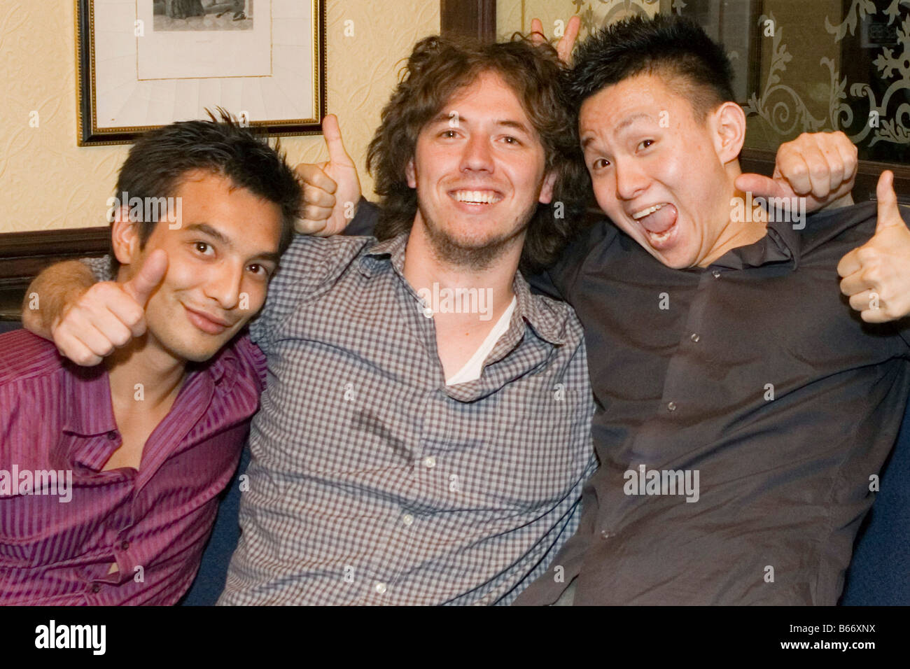 Three young men in a pub in central London Stock Photo
