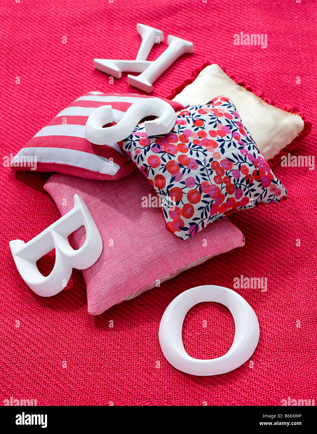 Cushions and letters on a carpet Stock Photo