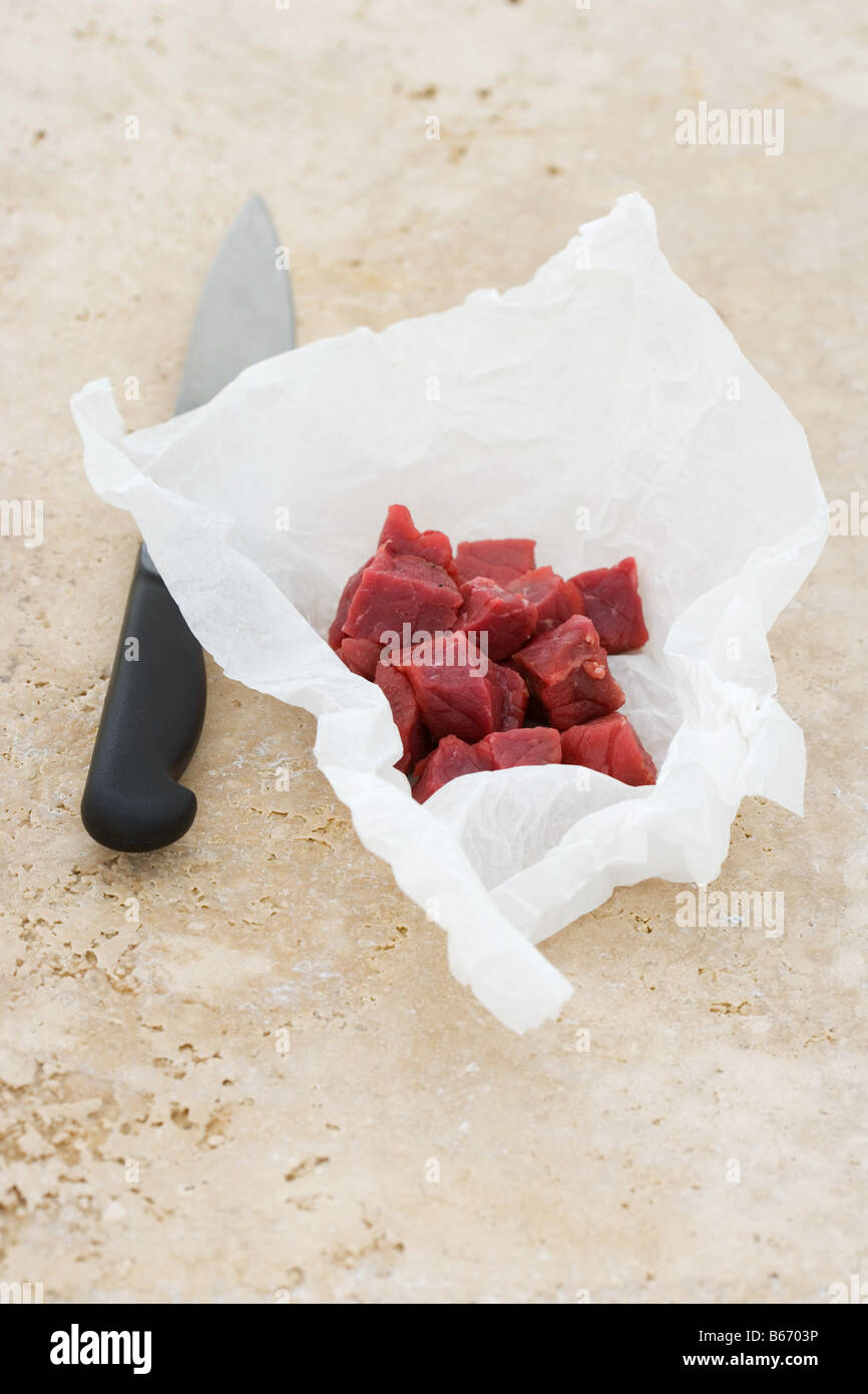 Cubed raw steak and a knife Stock Photo