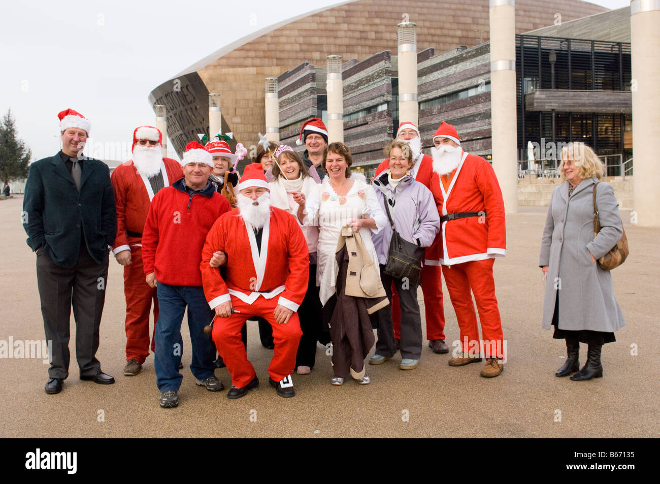 Group of adult friends celebrating christmas in Cardiff dressed up as Santa Claus and christmas faeries,  Wales UK Stock Photo
