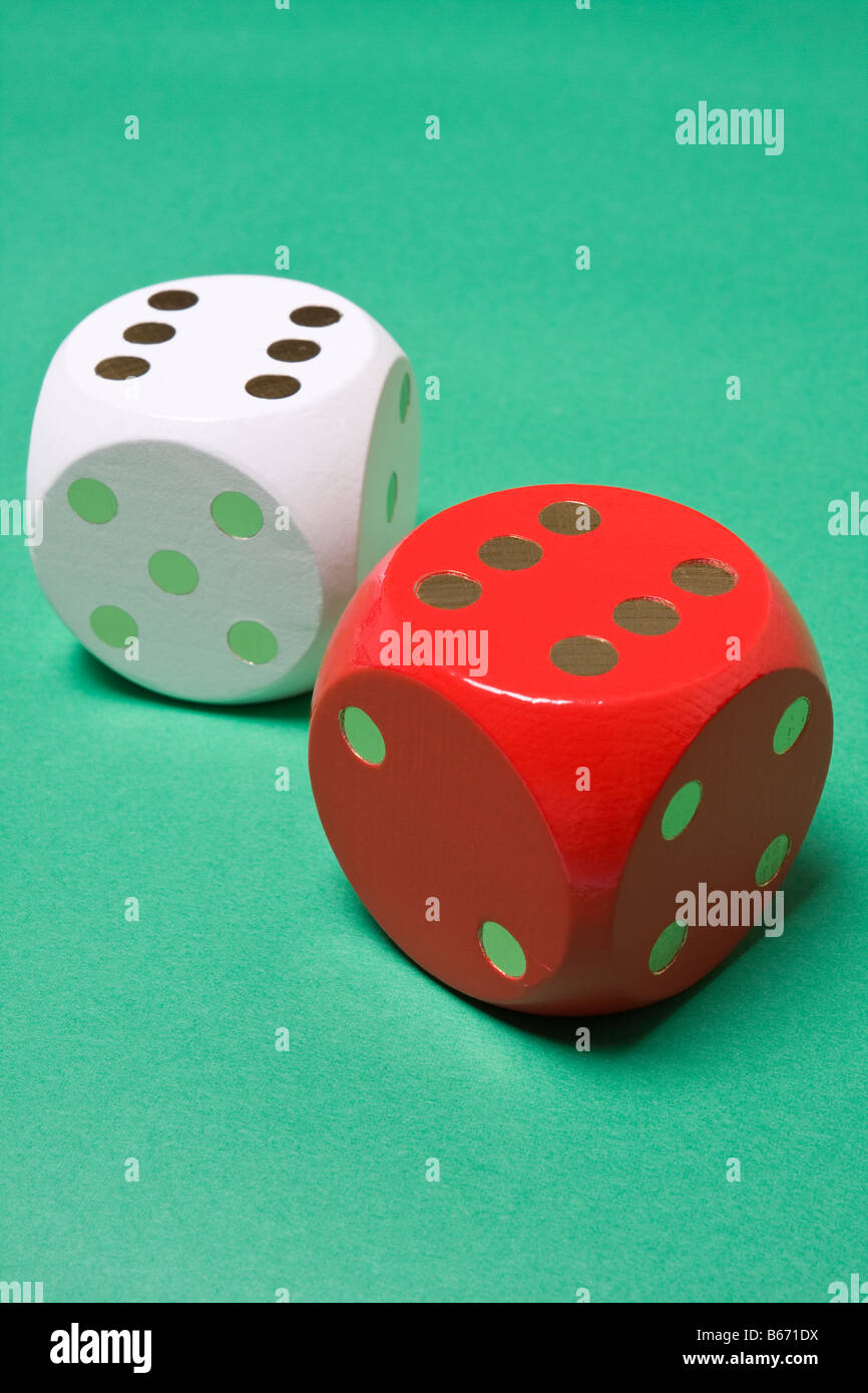 Red and white dice on green background showing double six Stock Photo