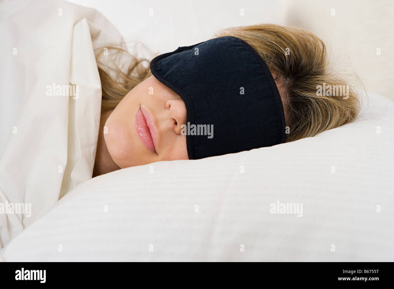 Woman sleeping with eye mask on Stock Photo Alamy