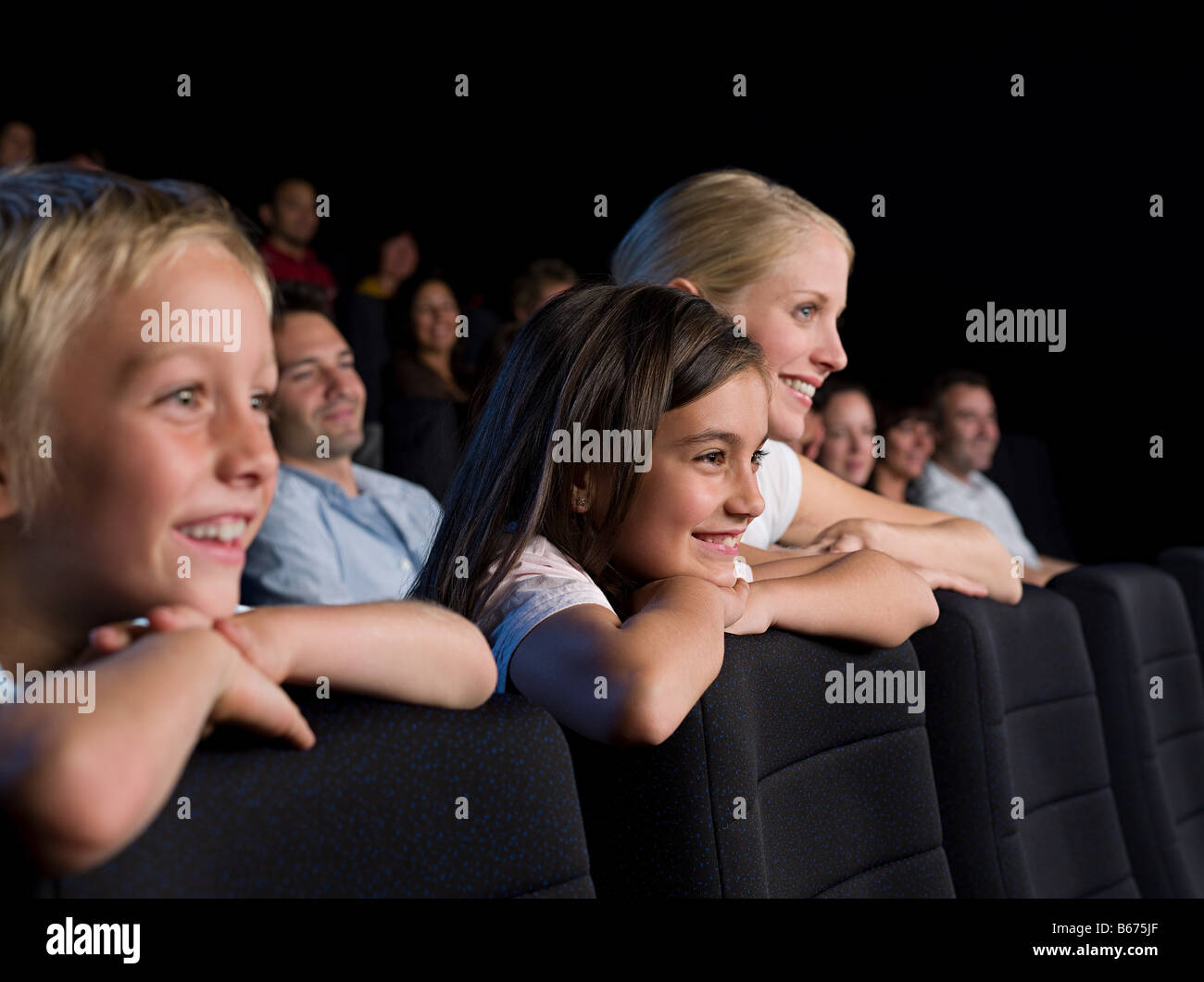 A mother and her children watching a movie Stock Photo