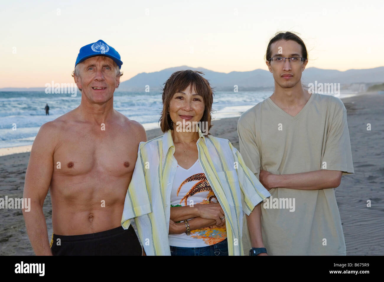 A family at a beach in Marbella, Spain at dusk Stock Photo