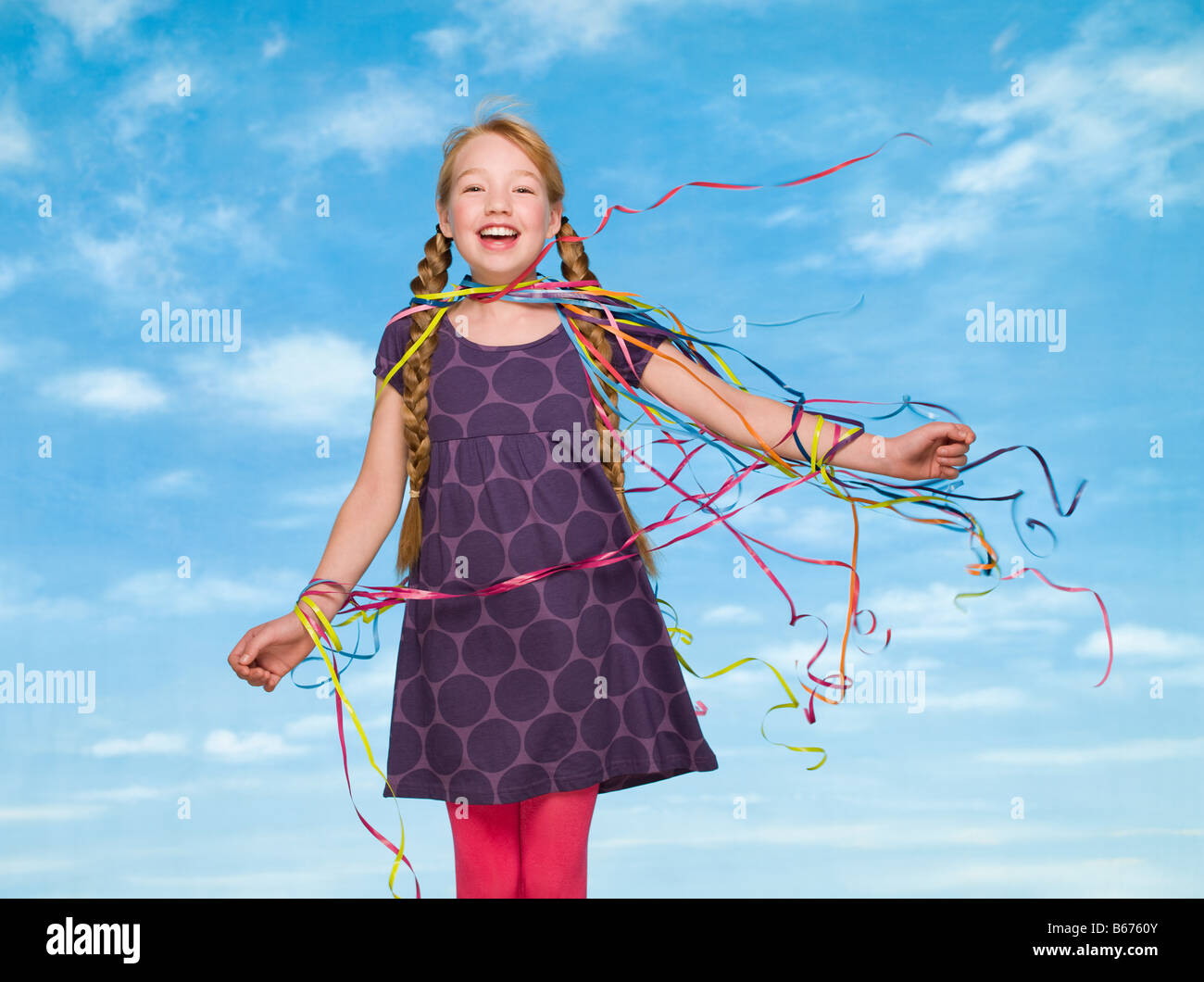 A girl covered in streamers Stock Photo