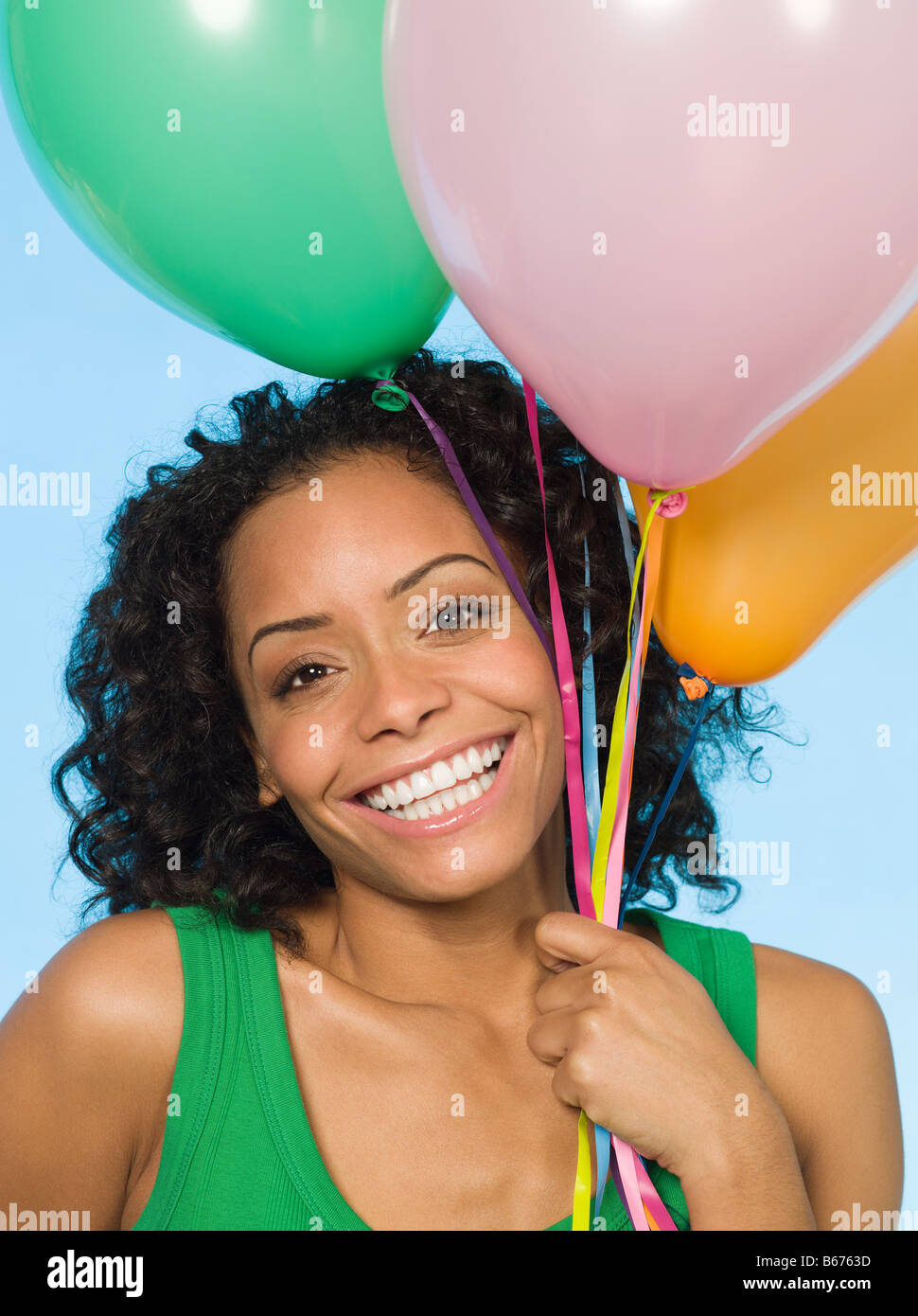 Young woman holding balloons Stock Photo