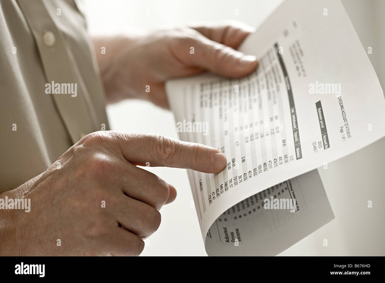 A man holding a bank statement Stock Photo - Alamy