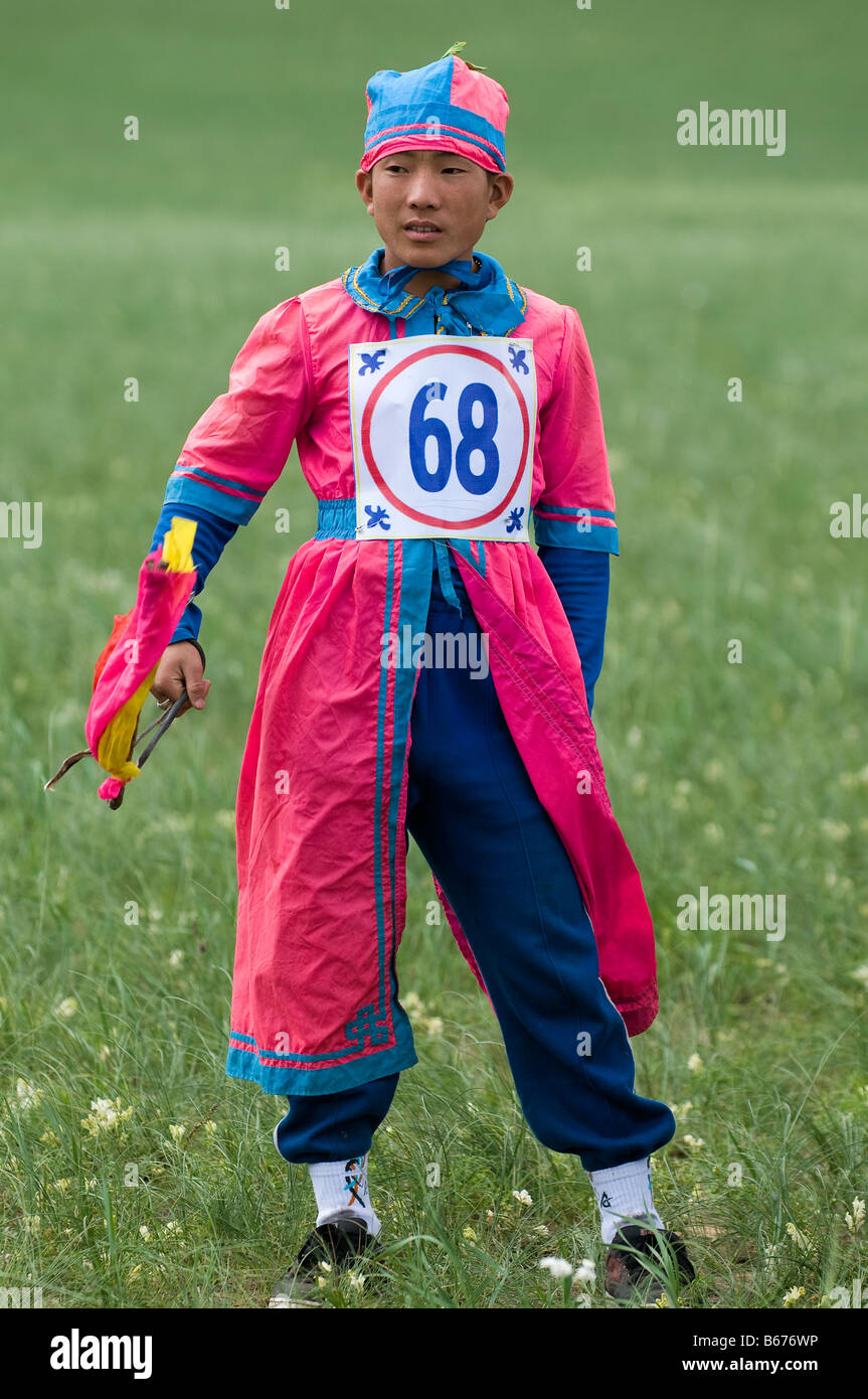 Boy jockey awaits horse race at summertime Naadam Festival Xiwuzhumuqinqi Inner Mongolia China Stock Photo