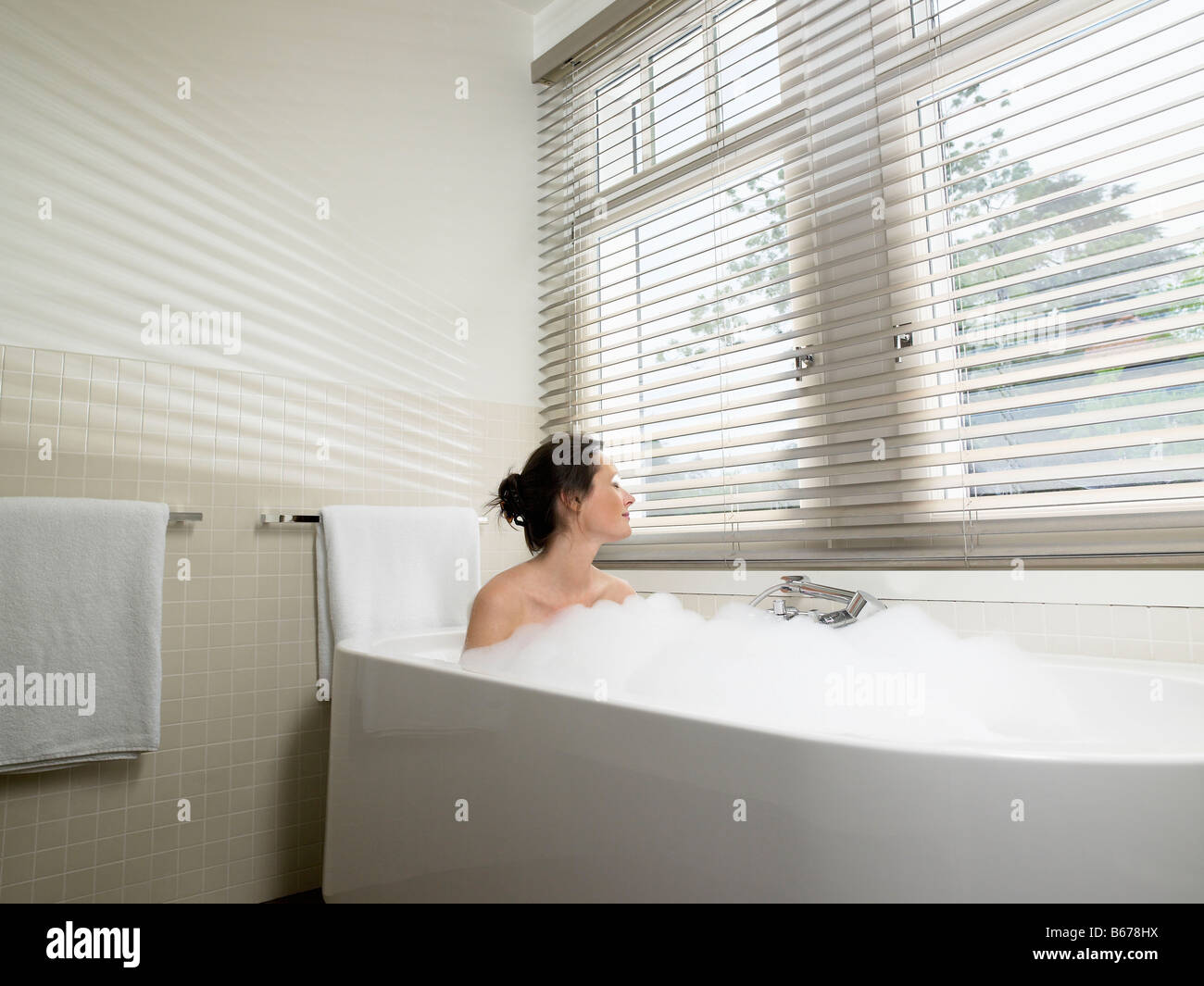 Woman in bathroom, taking a bath Stock Photo Alamy
