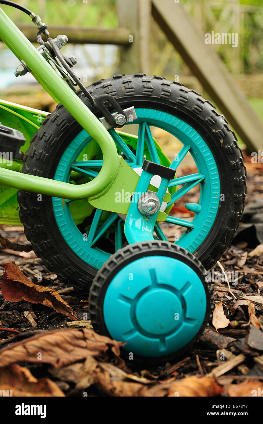 Childs Green Bicycle with Stabilisers Stock Photo