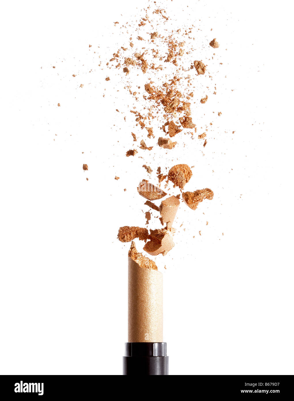 Exploding golden lipstick Stock Photo