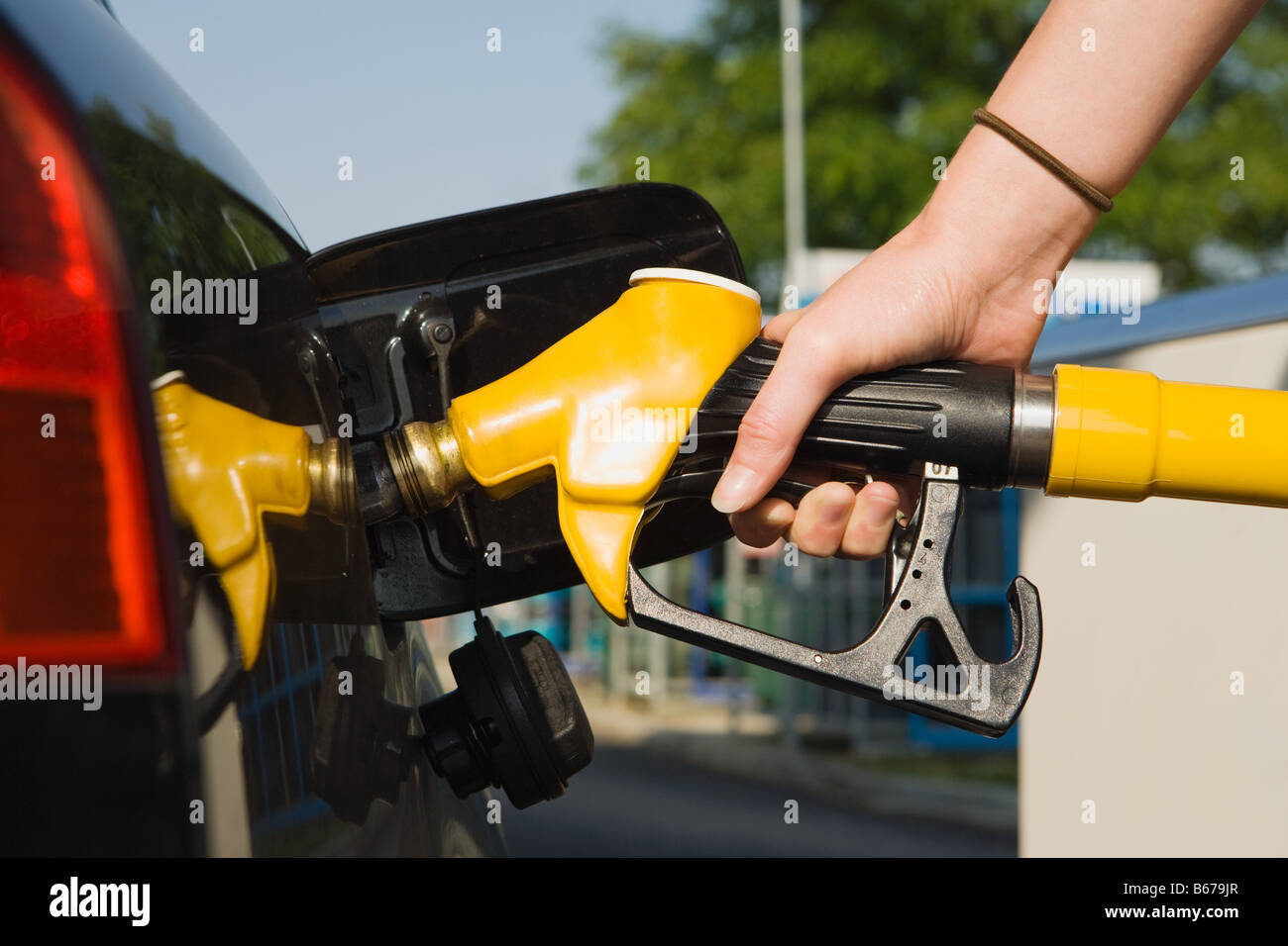 Person using petrol pump Stock Photo