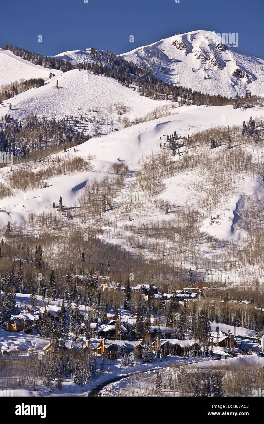 PARK CITY UTAH USA Deer Valley Resort ski area Skiers on chair lift with Park City in distance