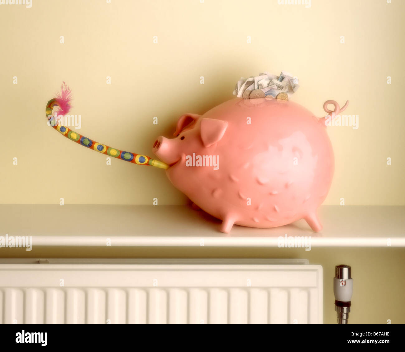 A very happy Fat Piggy Bank saving money on its Heating. Stock Photo