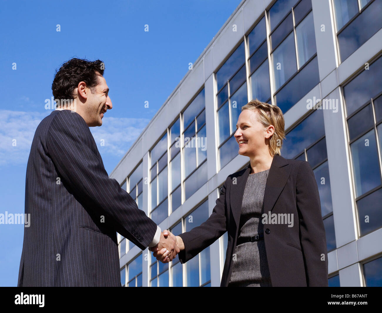 Business man & woman in front of office Stock Photo - Alamy