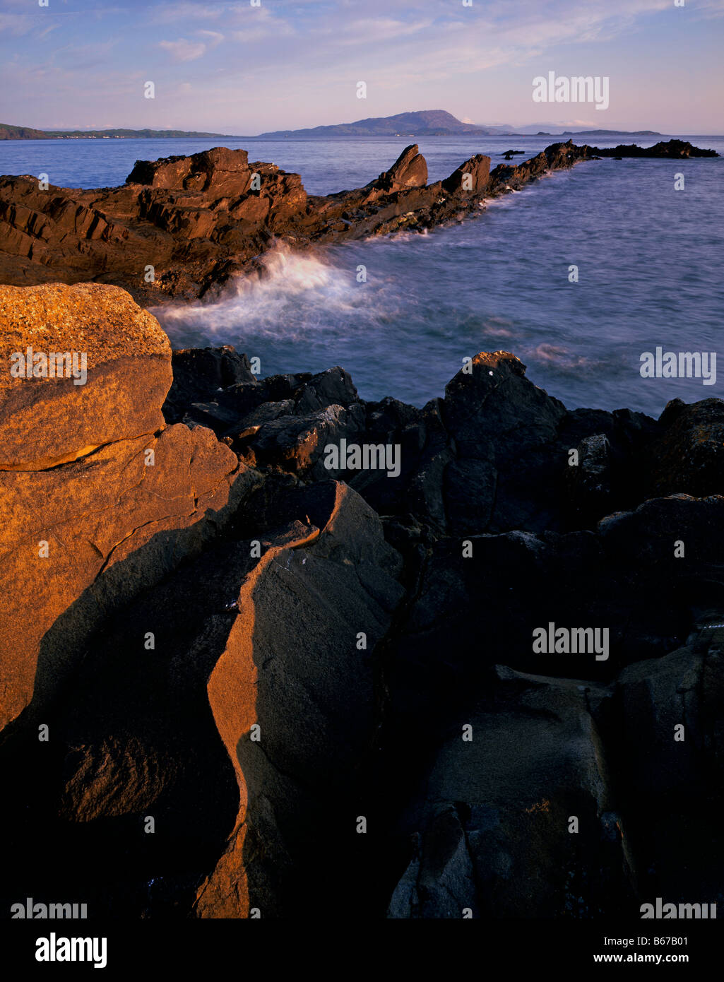 Isle of Scarba viewed from slate and basalt shore at Easdale, Argyll, Scotland, UK. Stock Photo