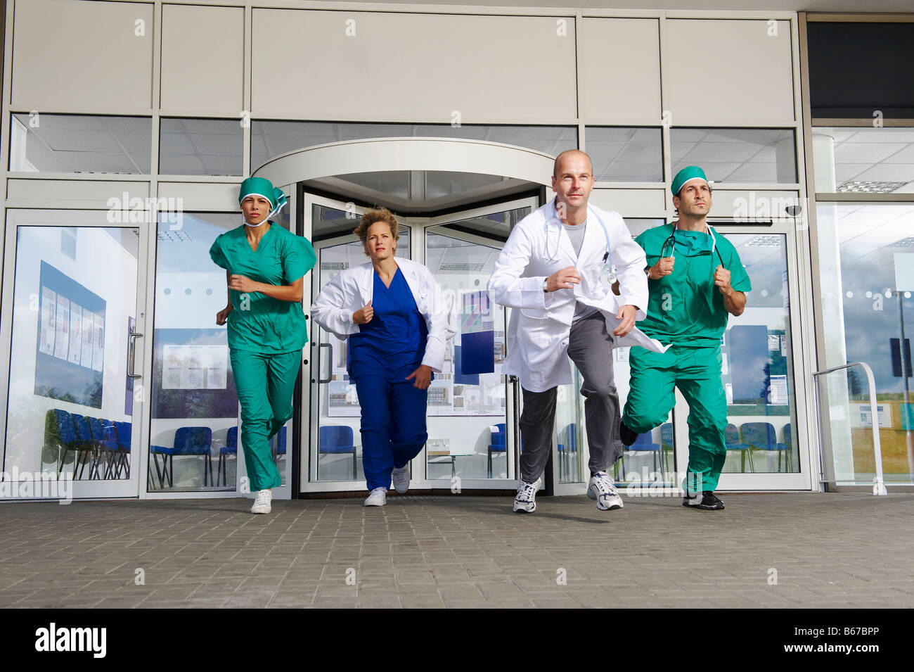 Medical team rushing out of door Stock Photo