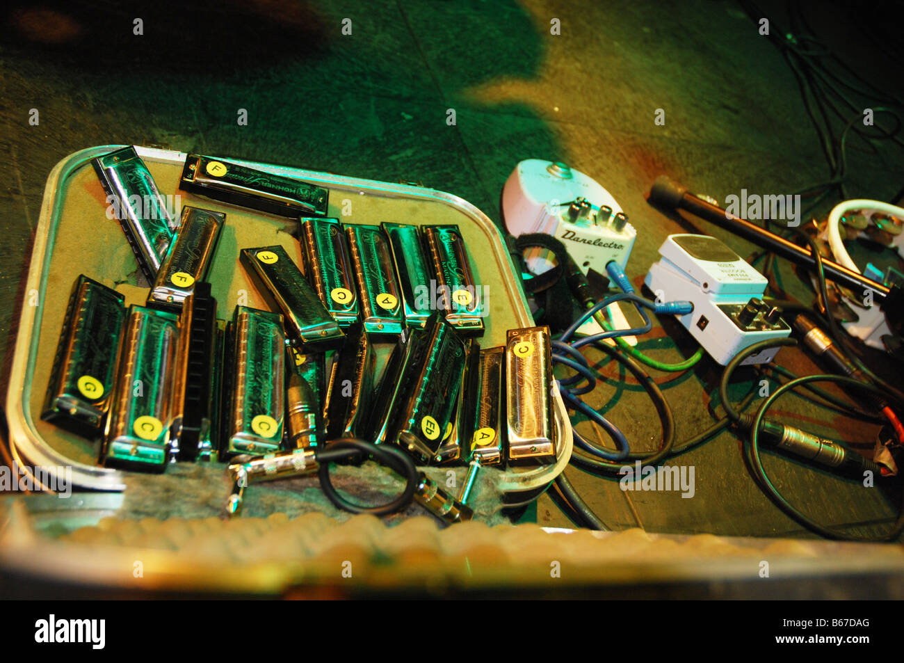 case with harmonicas and sound equipment on stage at rock concert Stock Photo