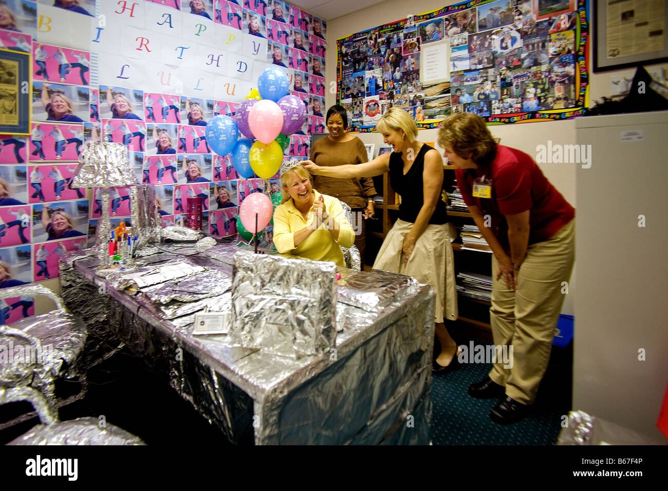 Colleagues of California school celebrating birthday in office Stock Photo