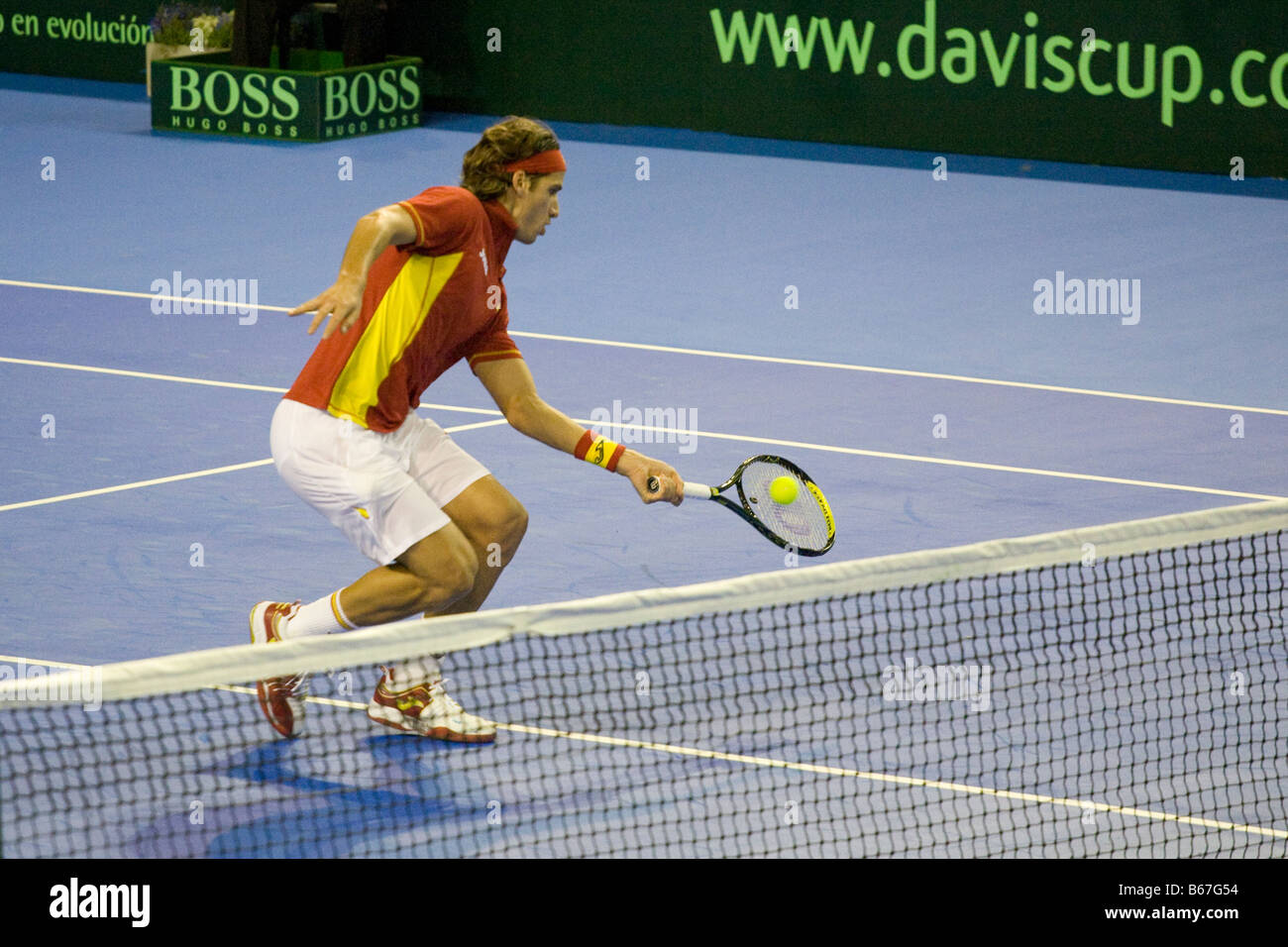 Spanish tennis player Feliciano Lopez hitting a drive shot volley near the net during the 2008 Davis Cup final against argentini Stock Photo