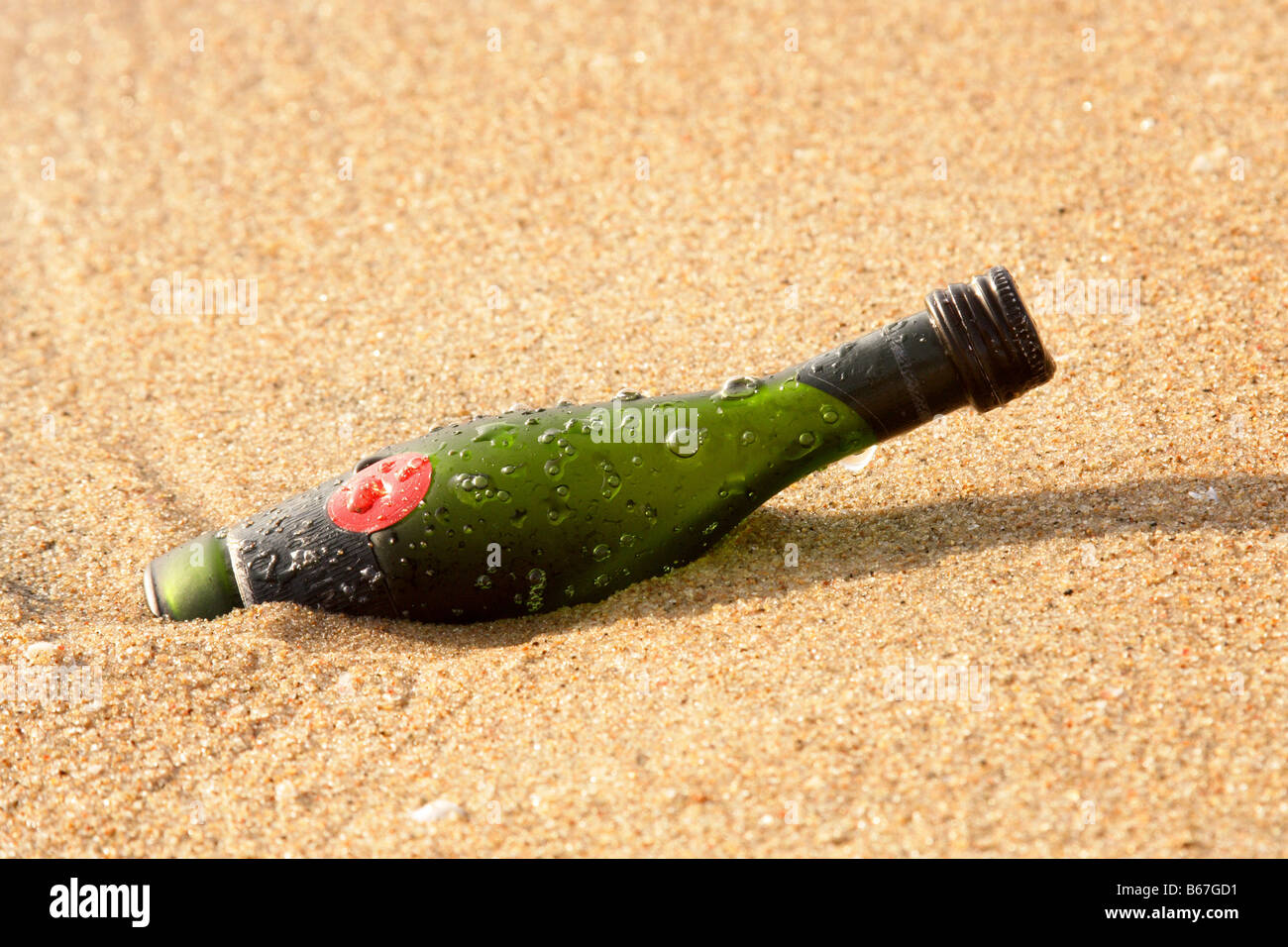 Wine bottle in the sand Stock Photo - Alamy