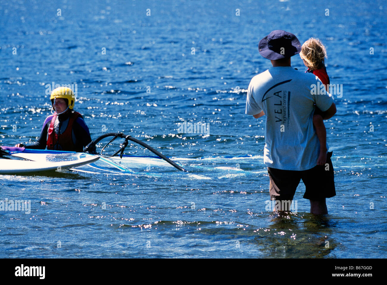 A Woman windsurfing with her Family on Nimpkish Lake on Vancouver