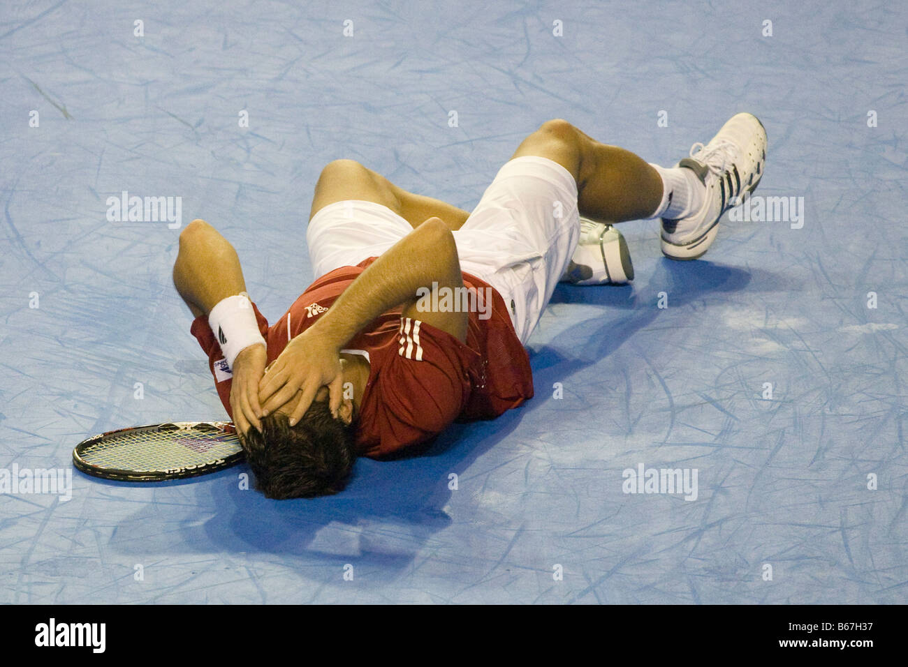 Spanish tennis player Fernando Verdasco falls to the floor to celebrate the winning of the 2008 Davis Cup final against argentin Stock Photo