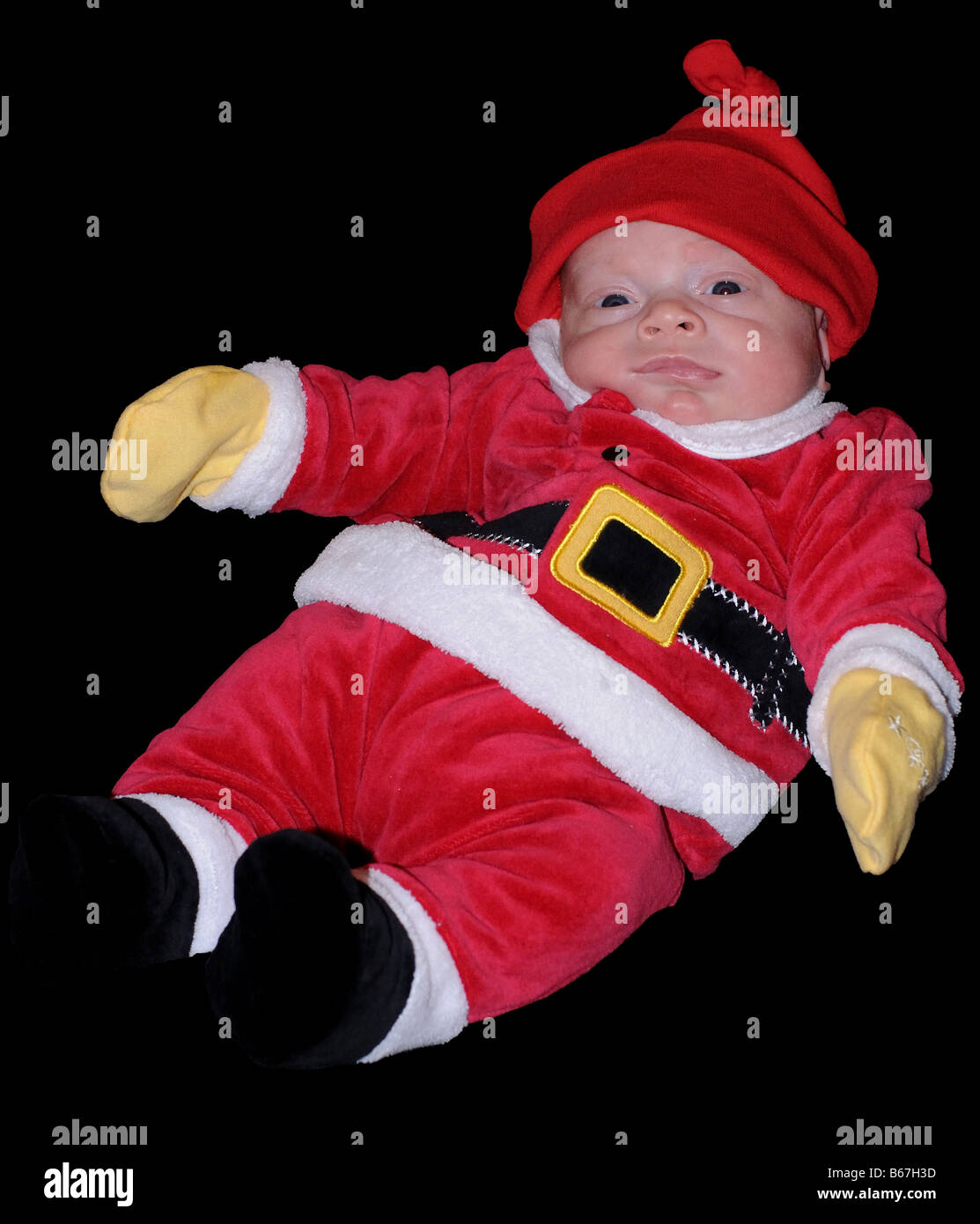 A cut-out of a baby dressed in a holiday Christmas Santa Clause suit. Merry Christmas Happy Holidays Ho Ho Ho! Chanukah baby. Stock Photo