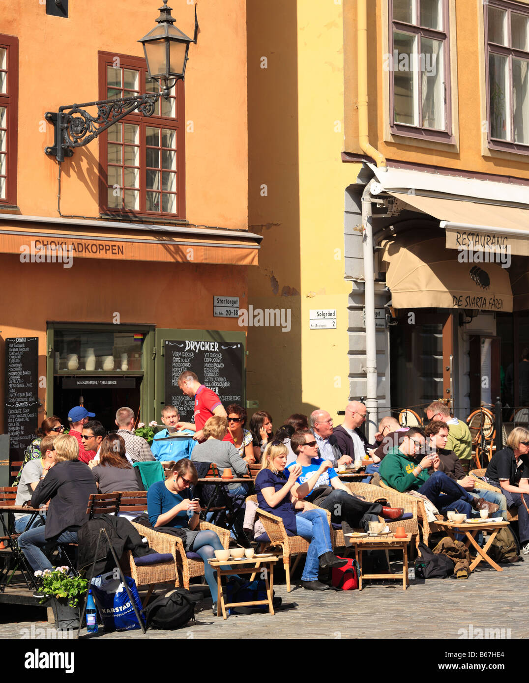 People seating in Cafe, street, Gamla stan, Old Town, Stockholm, Sweden Stock Photo