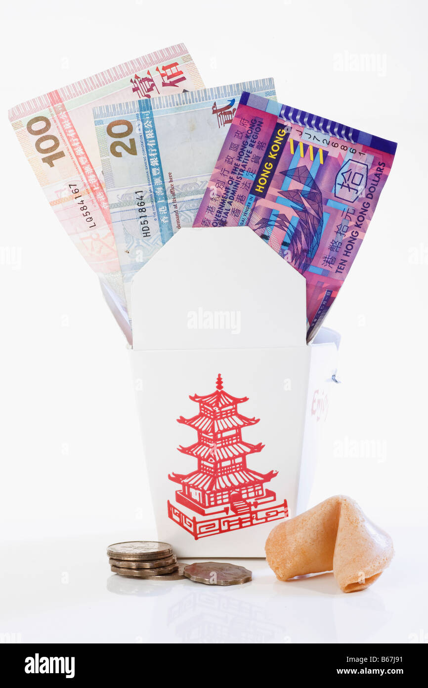 Paper currency in a donation box with coins and fortune cookie Stock Photo