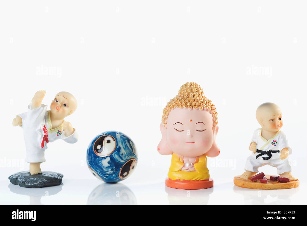 Close-up of figurines with a yin yang ball Stock Photo