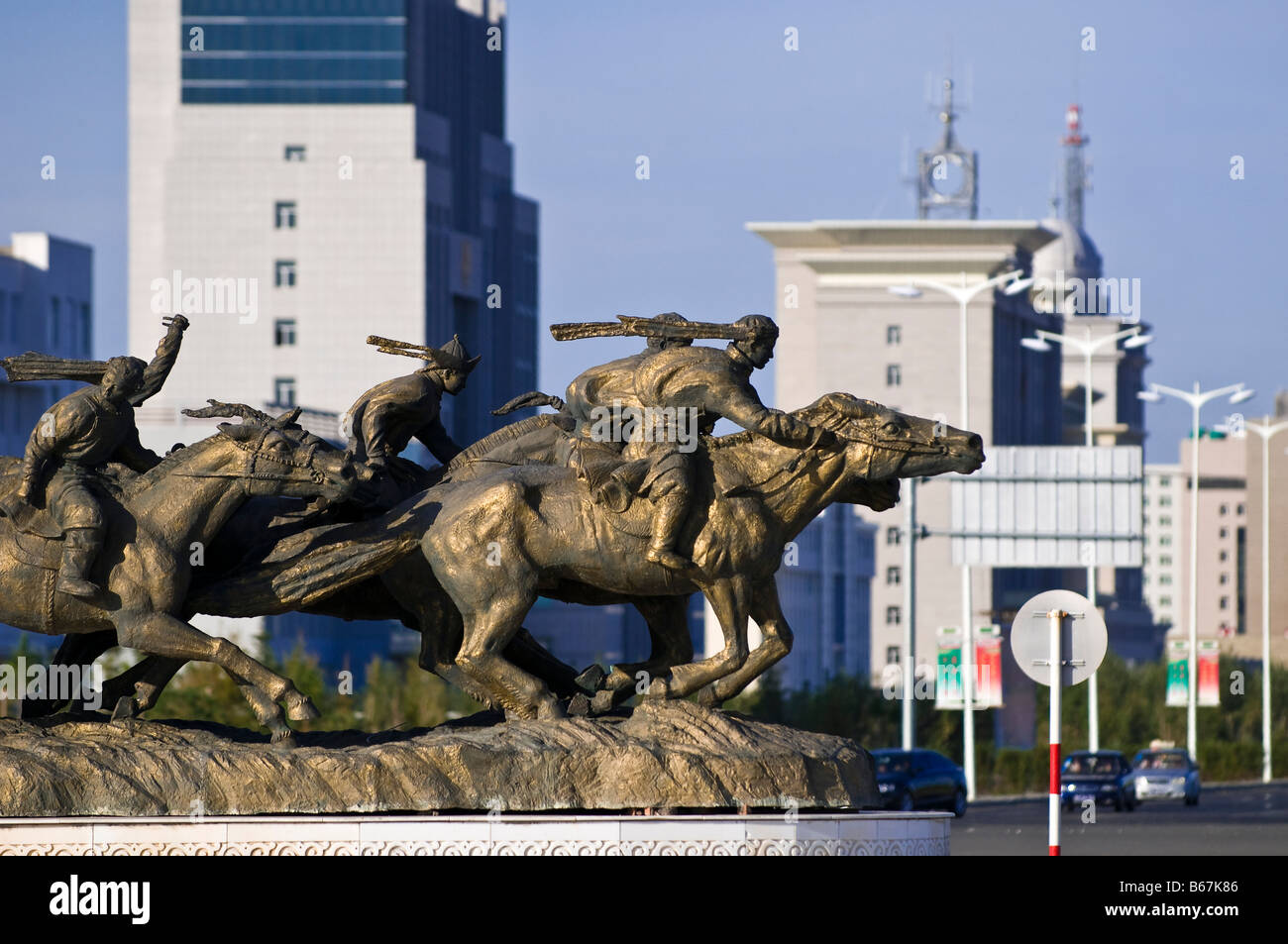 Statue of Mongolian horsemen near newly built buildings Xiwuzhumuqinqi