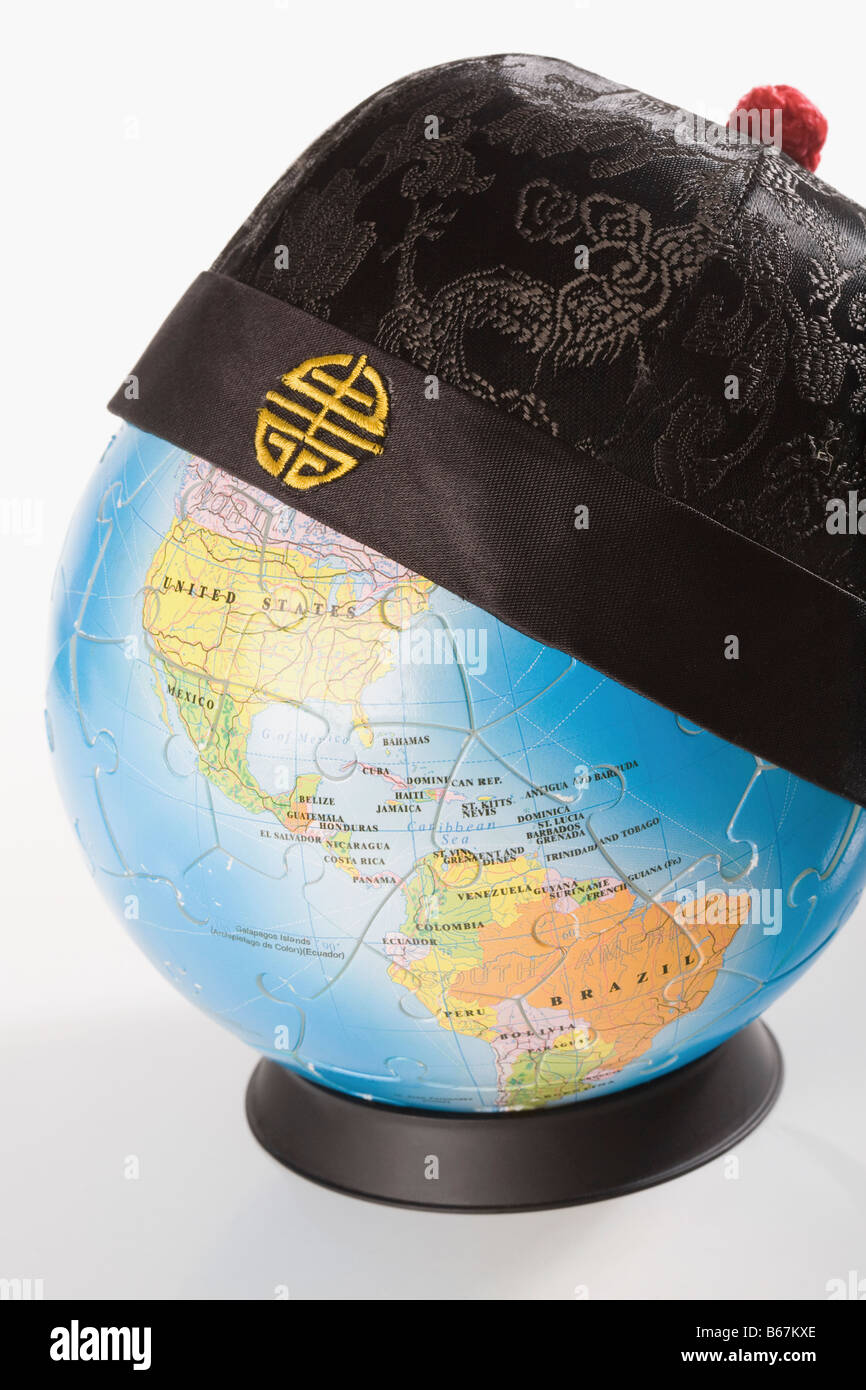 Chinese traditional cap on a globe Stock Photo