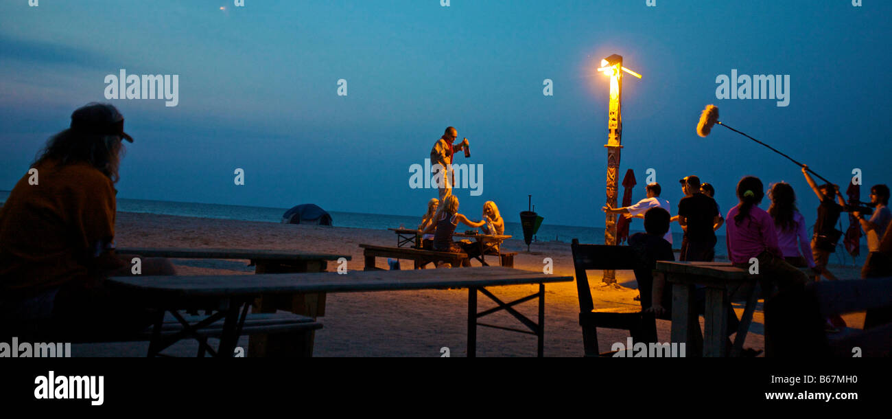 The filming of a movie on the beach at dusk Stock Photo