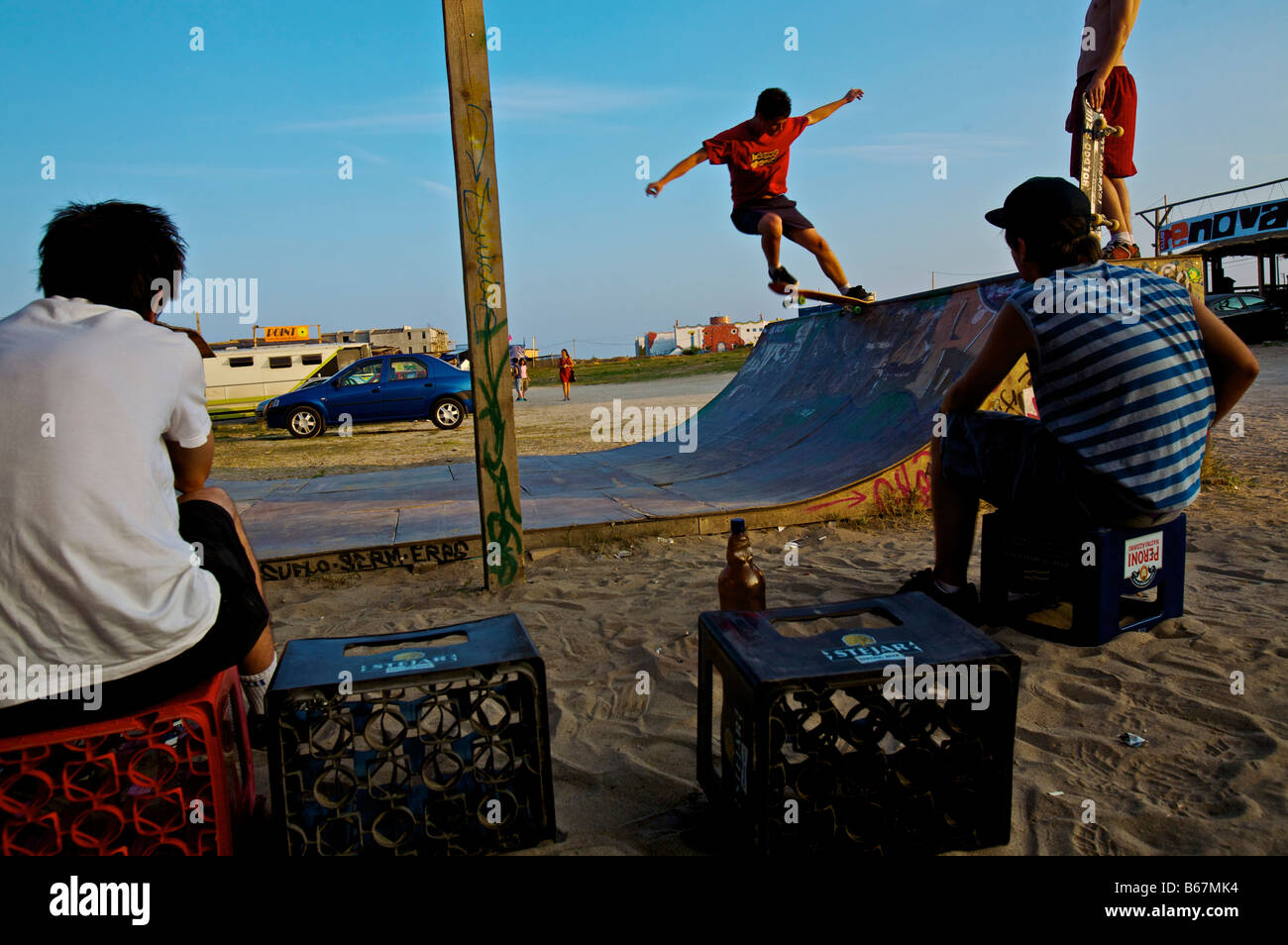 Teens skateboarding on the beach Stock Photo