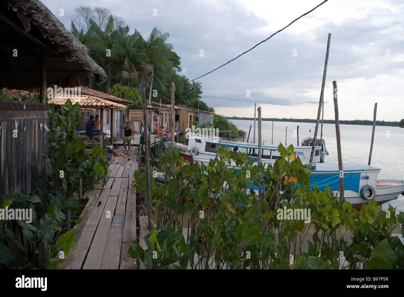 Boats and houses on stilts along the Amazon River, Combo Island, near