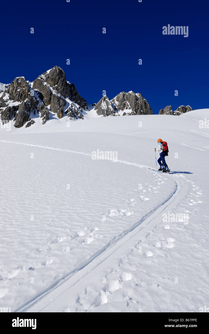 young woman ascending on ski track in Noppenkar, Allgaeu range, Allgaeu, Tyrol, Austria Stock Photo