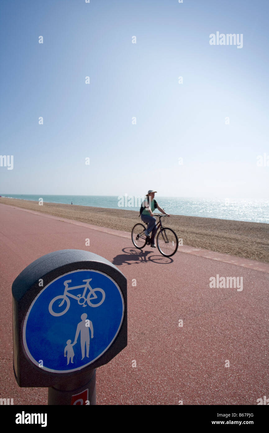 Cyclist on [coastal cycle route] at Hythe Kent [National Cycle Network route 2] Stock Photo