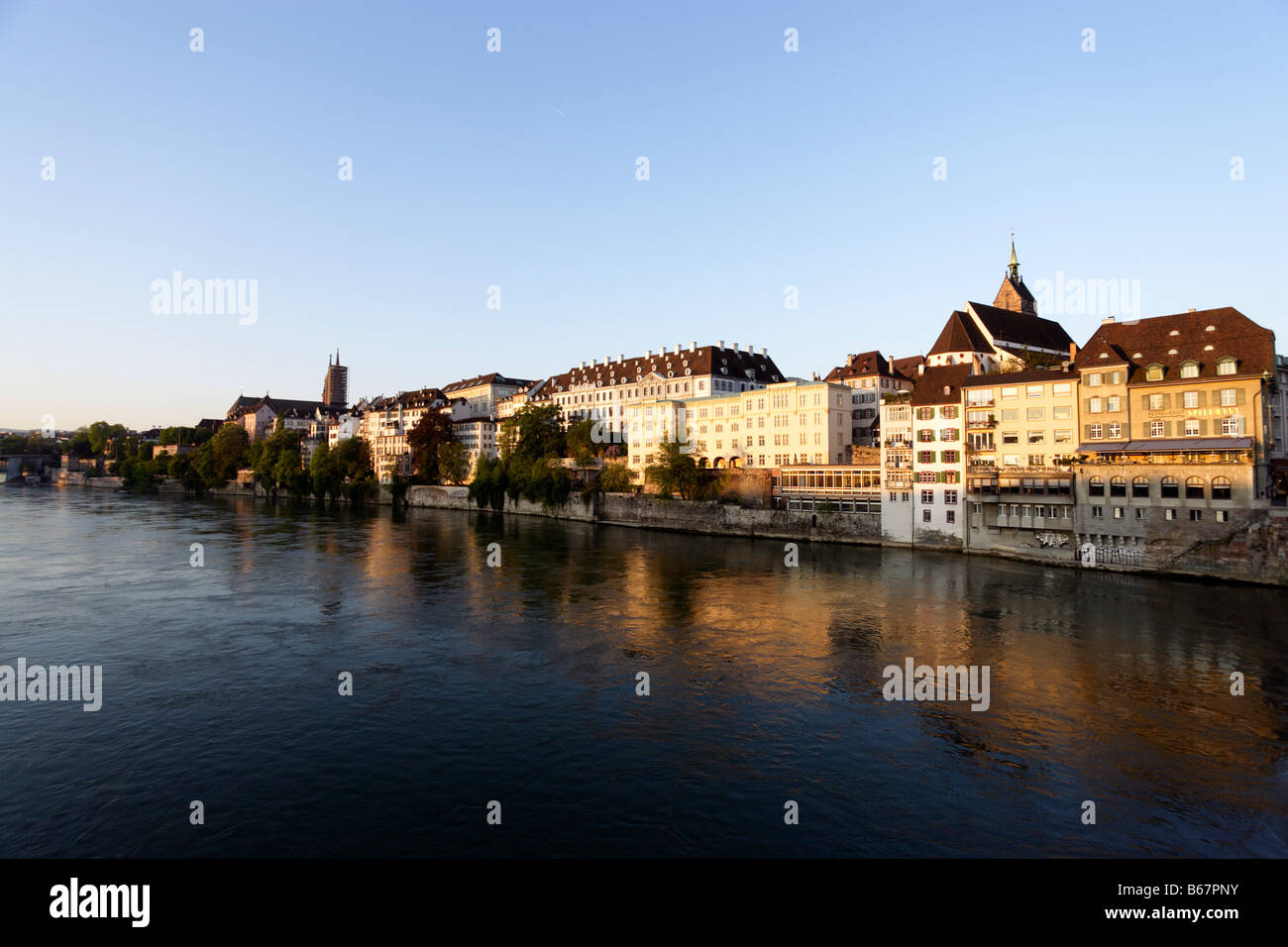 Riverbank with Basel Muenster and St. Martins Church in the background, River Rhine, Basel, Switzerland Stock Photo