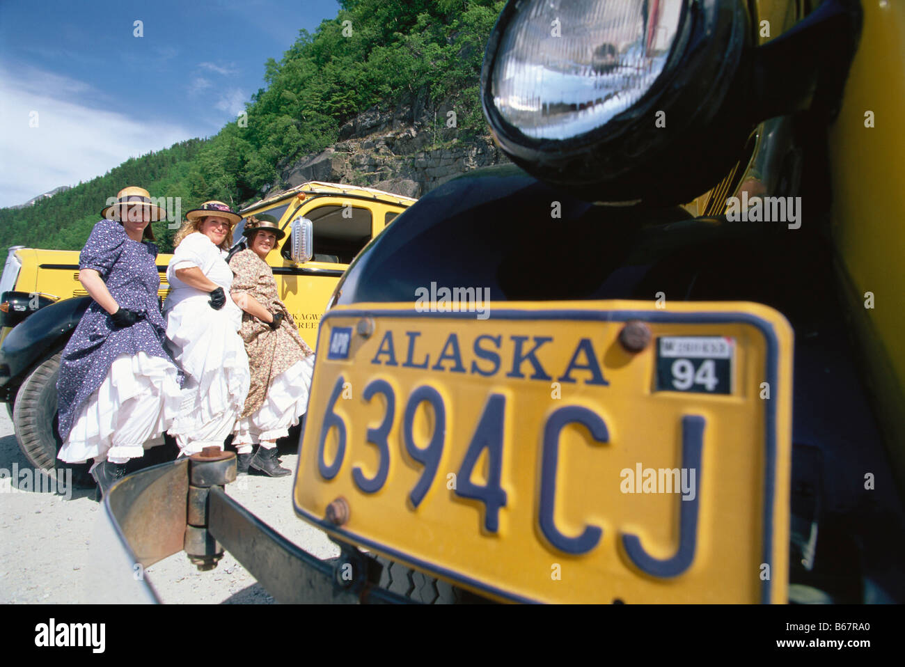 Three female drivers of tour buses in traditional dress, Skagway