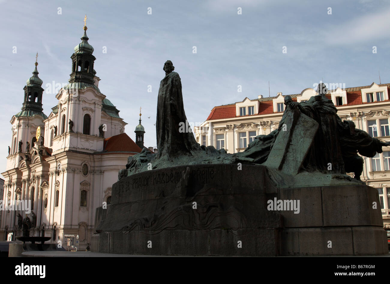 Jan Hus statue with the Church of St Nicholas in the background at the