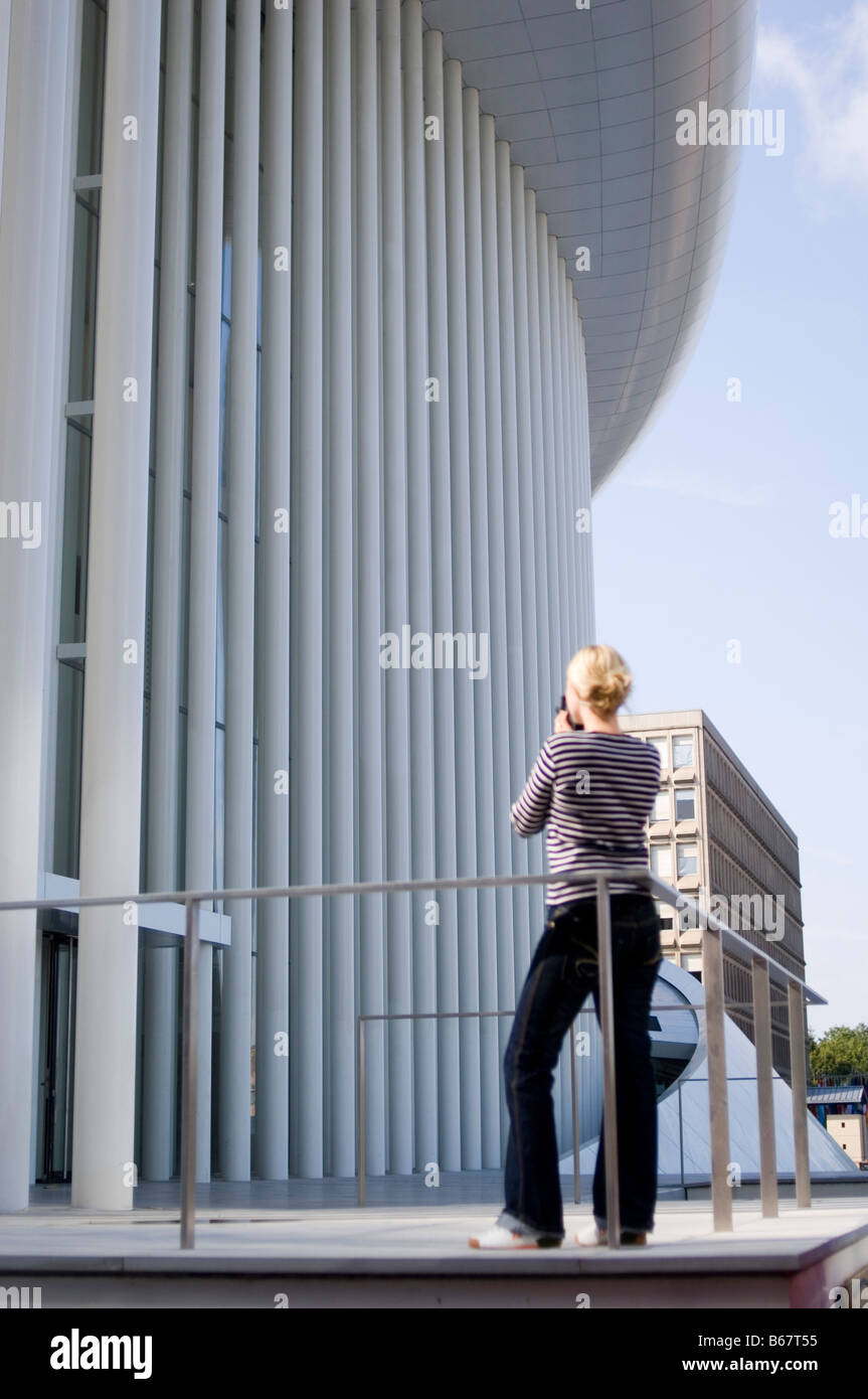 Young woman photographing Philarmonie, Luxembourg, Luxembourg Stock Photo