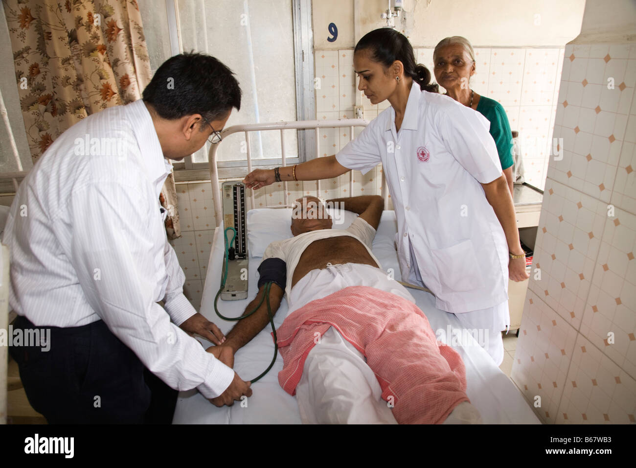 Indian doctor treating patient hi-res stock photography and images - Alamy