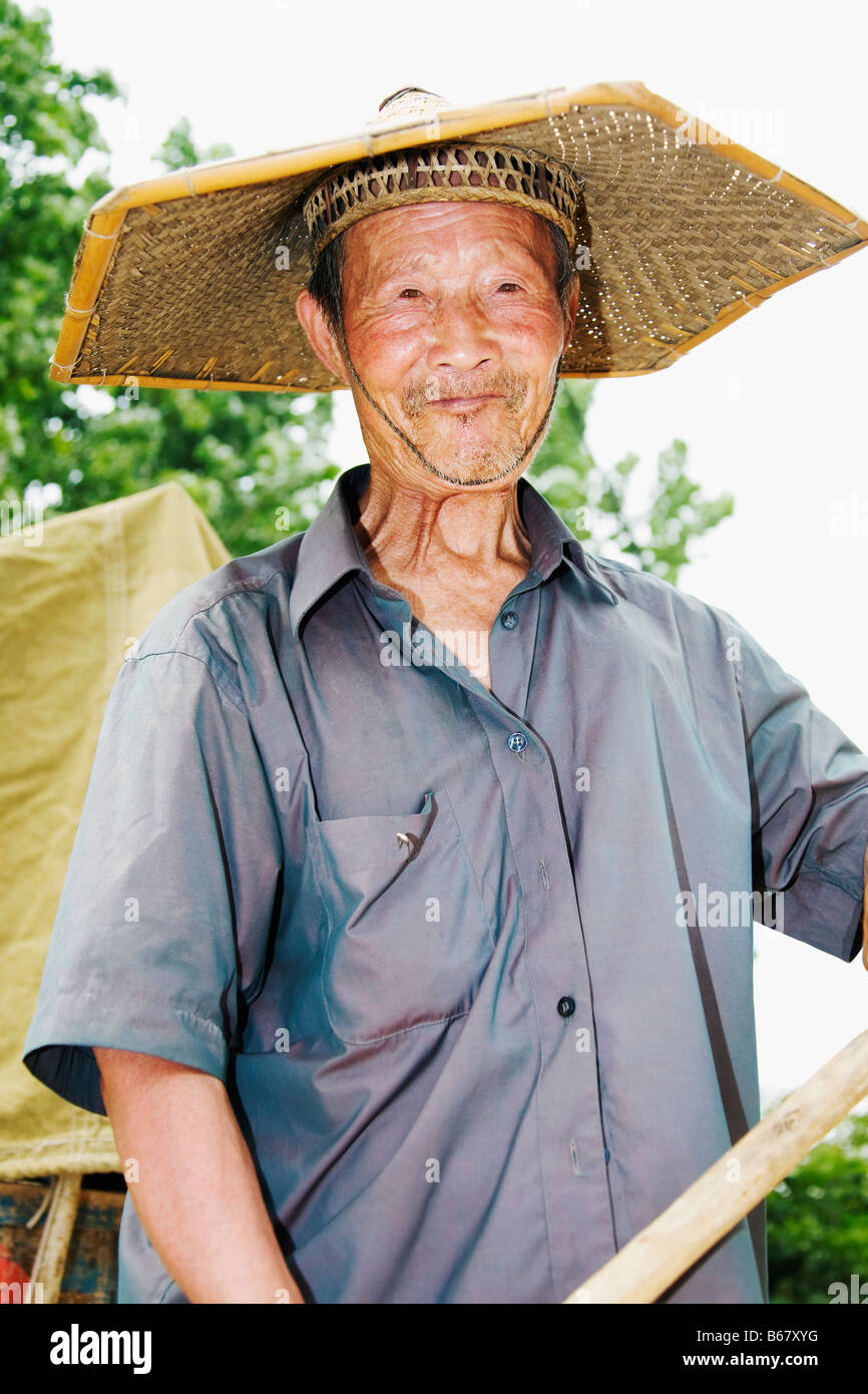 Close-up of a farmer wearing an Asian style conical hat, Zhigou, Shandong  Province, China Stock Photo - Alamy