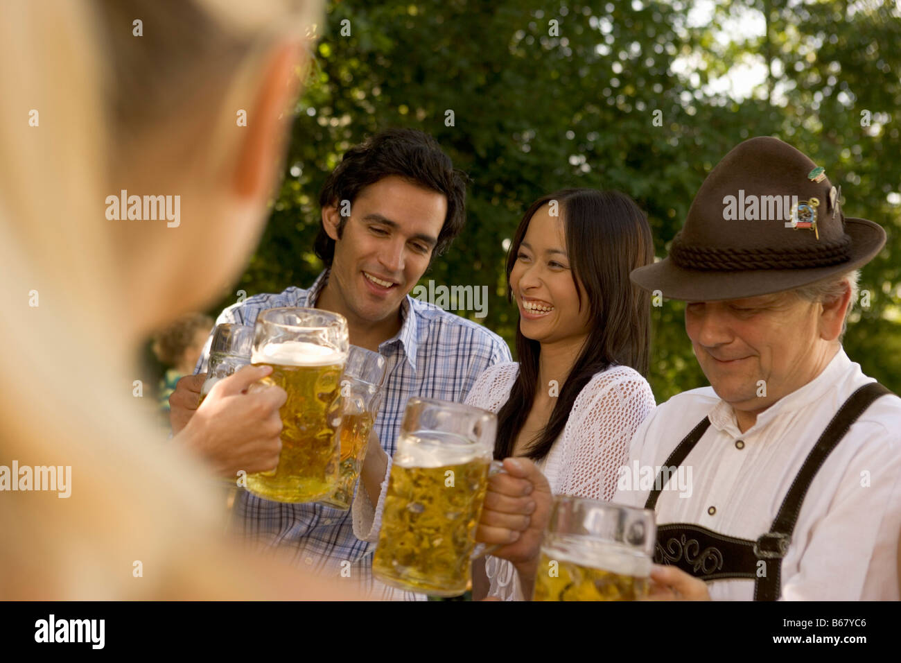 Friends toasting in beergarden, Bavaria, Germany Stock Photo