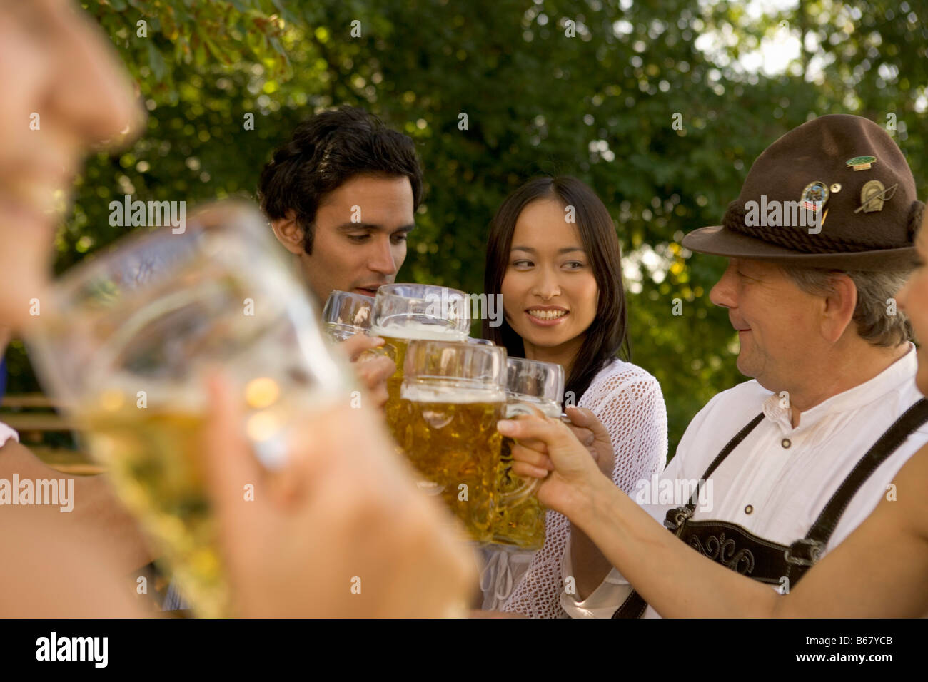 Friends toasting in beergarden, Bavaria, Germany Stock Photo
