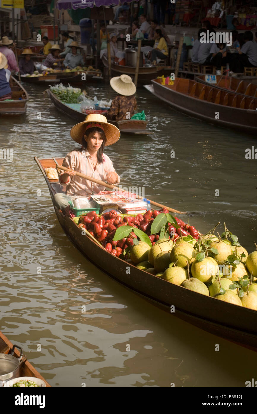 Woman in a wooden canoe at Floating Market, Damnoen Saduak, near