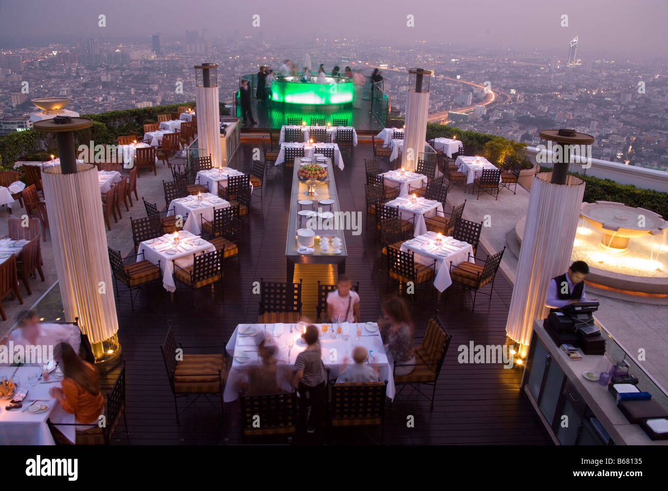 View over openair-bar "Sirocco Sky Bar" and Bangkok in the evening, State Tower, 247 m, The Dome, Bangkok, Thailand Stock Photo