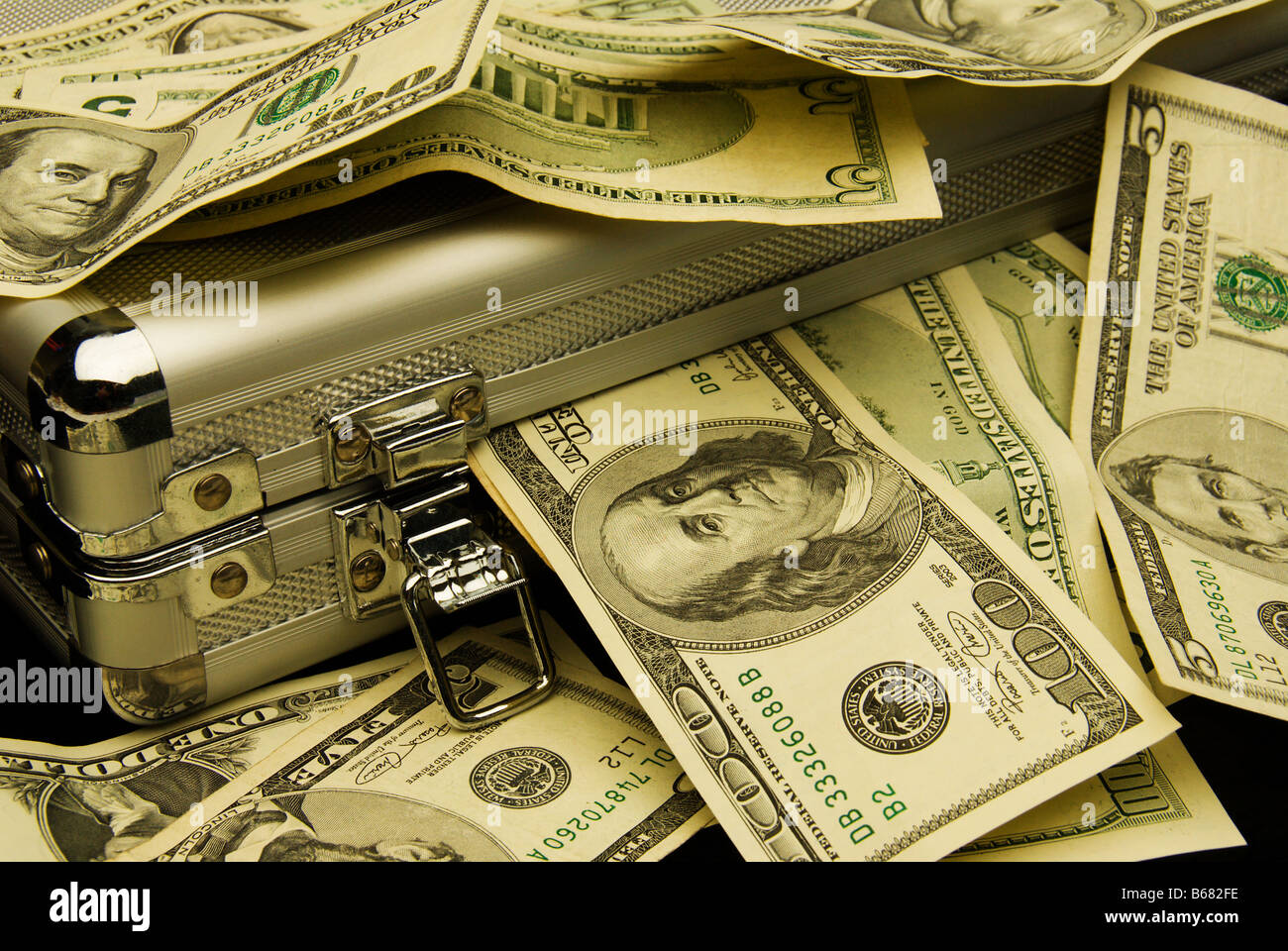Money box briefcase with piles of banknotes, concept financial gain. Stock Photo